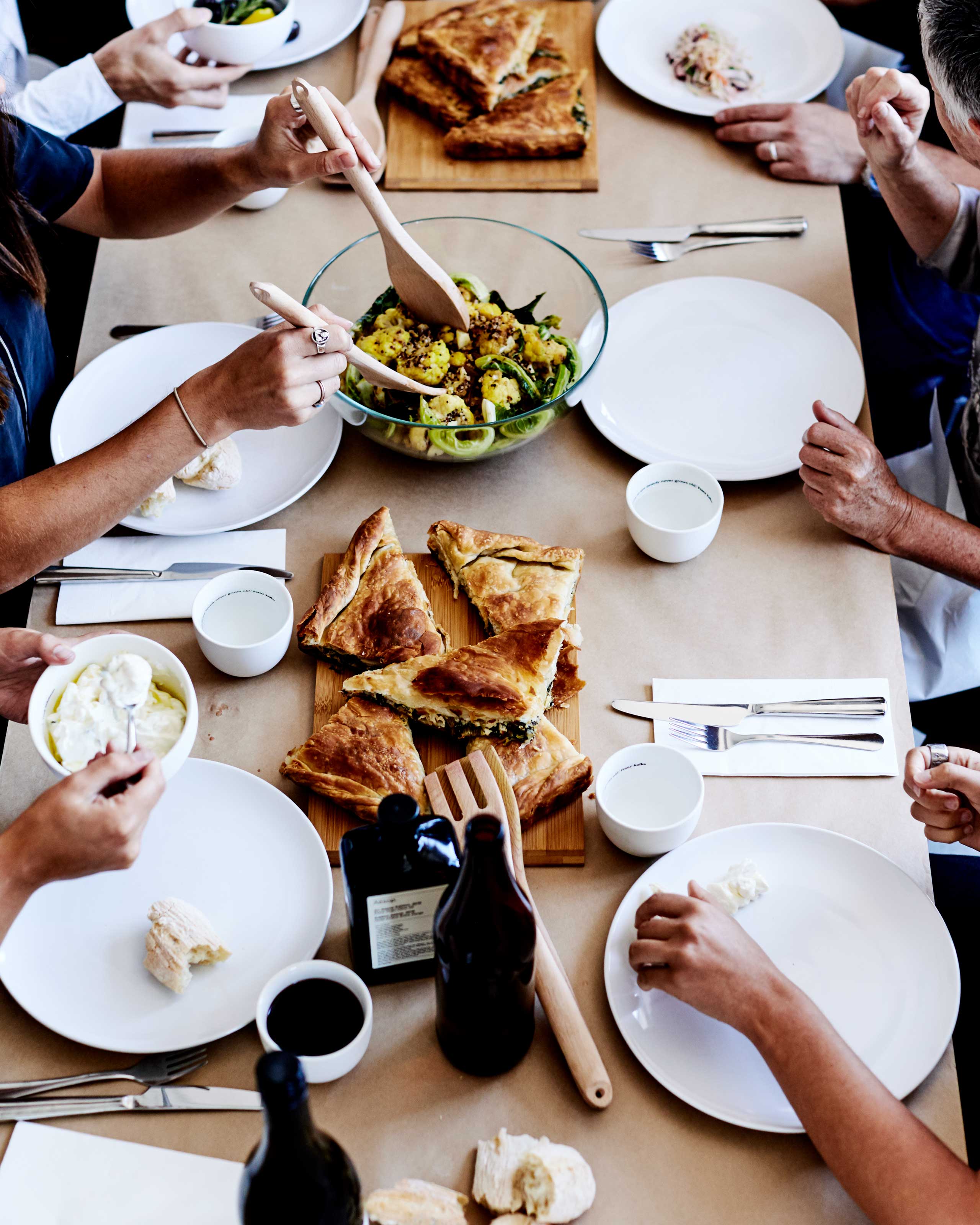 Staff share a meal around a table at Aesop's head office.