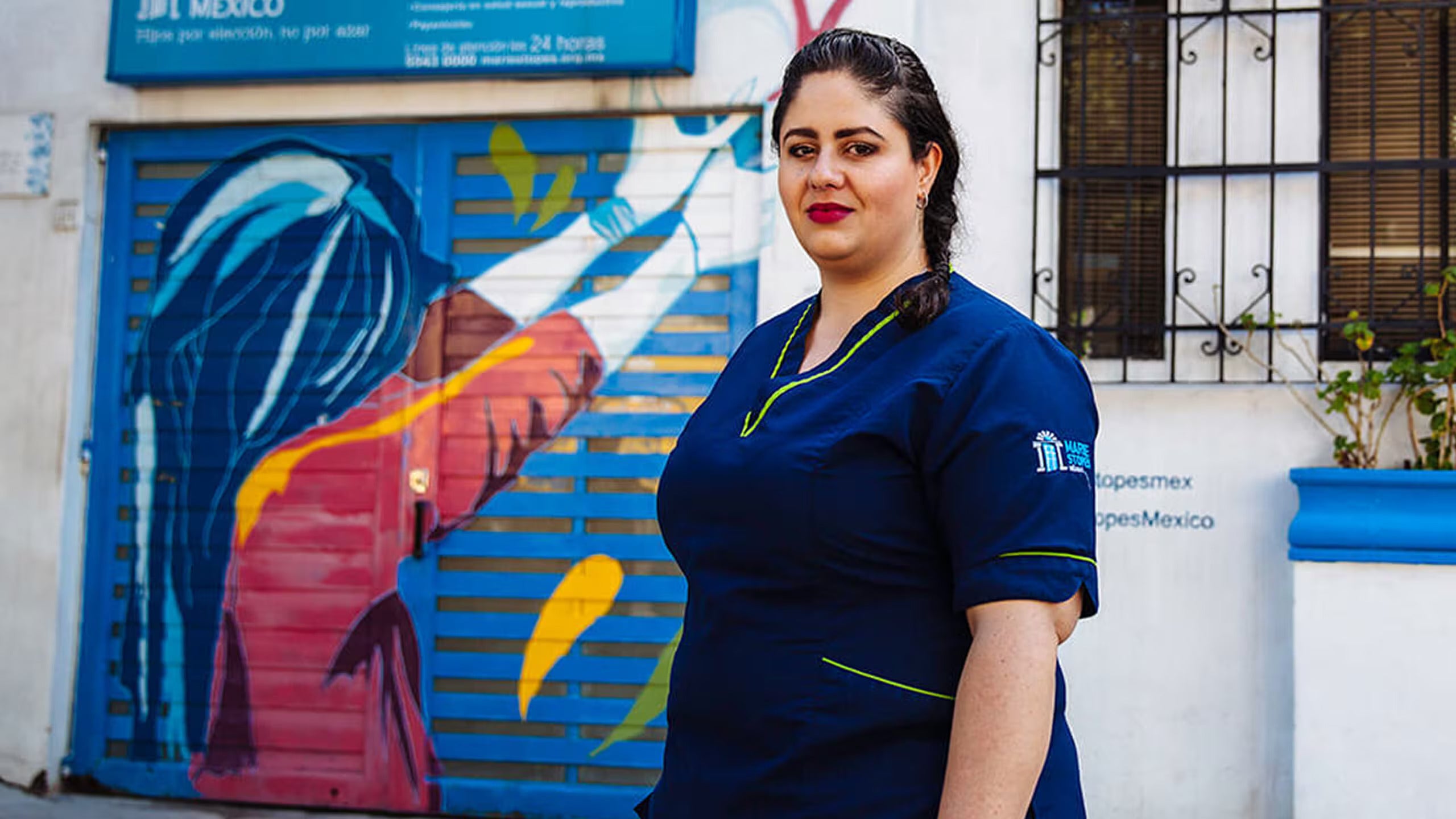 A woman wearing a healthcare uniform