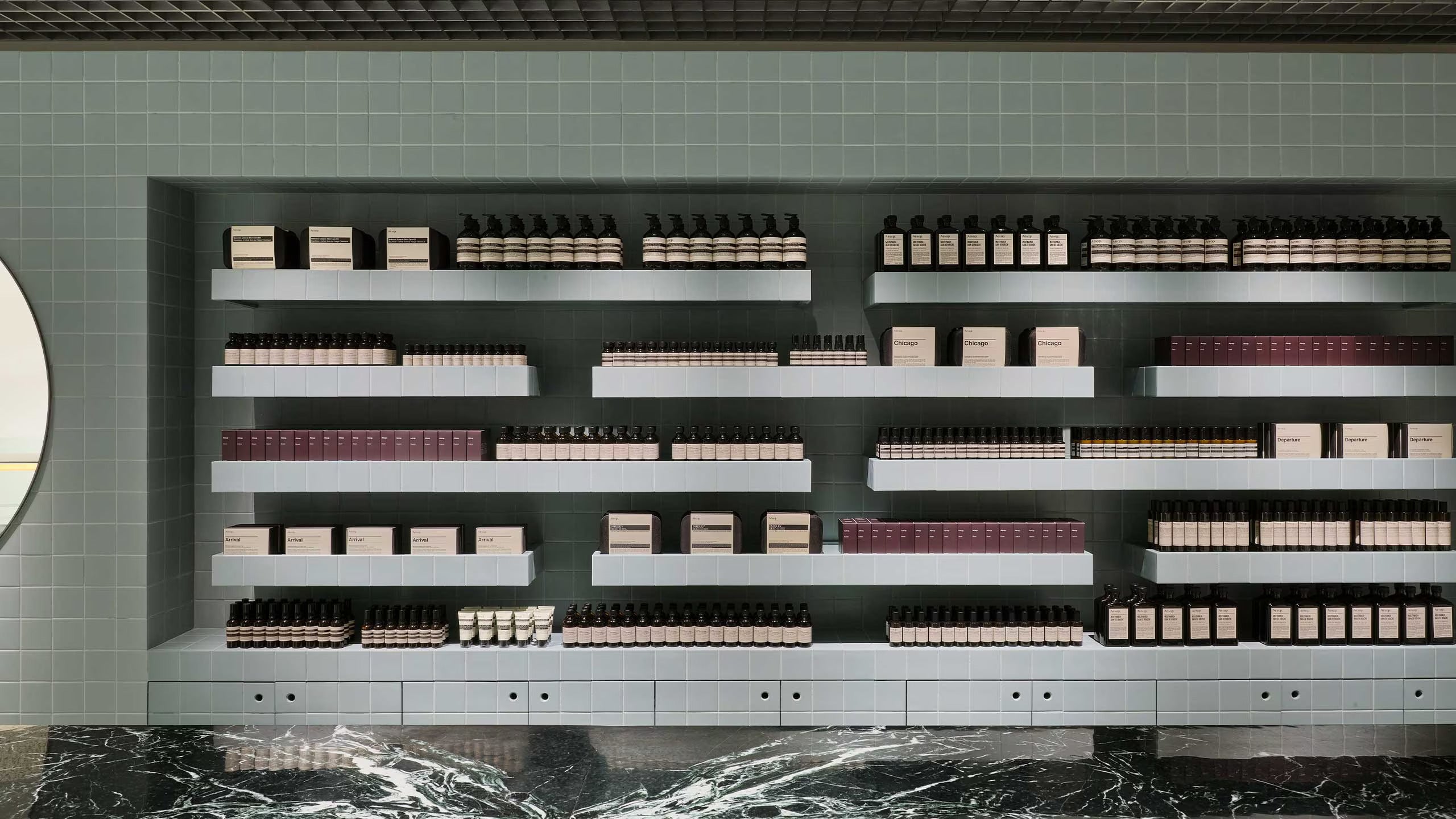Aesop products showcasing on the ceramic-tiled walls.