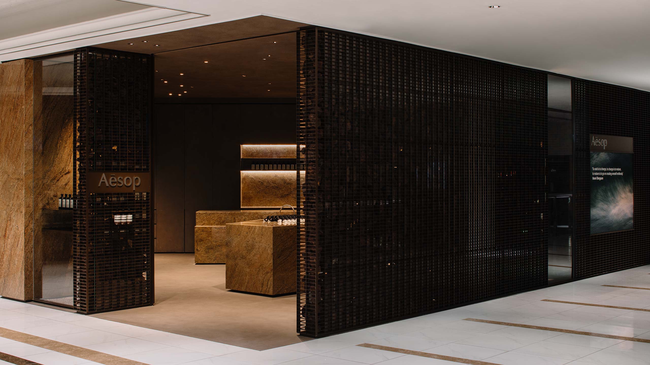 An exterior view of the store showing the dark steel grating that marks the perimeter of the store. 