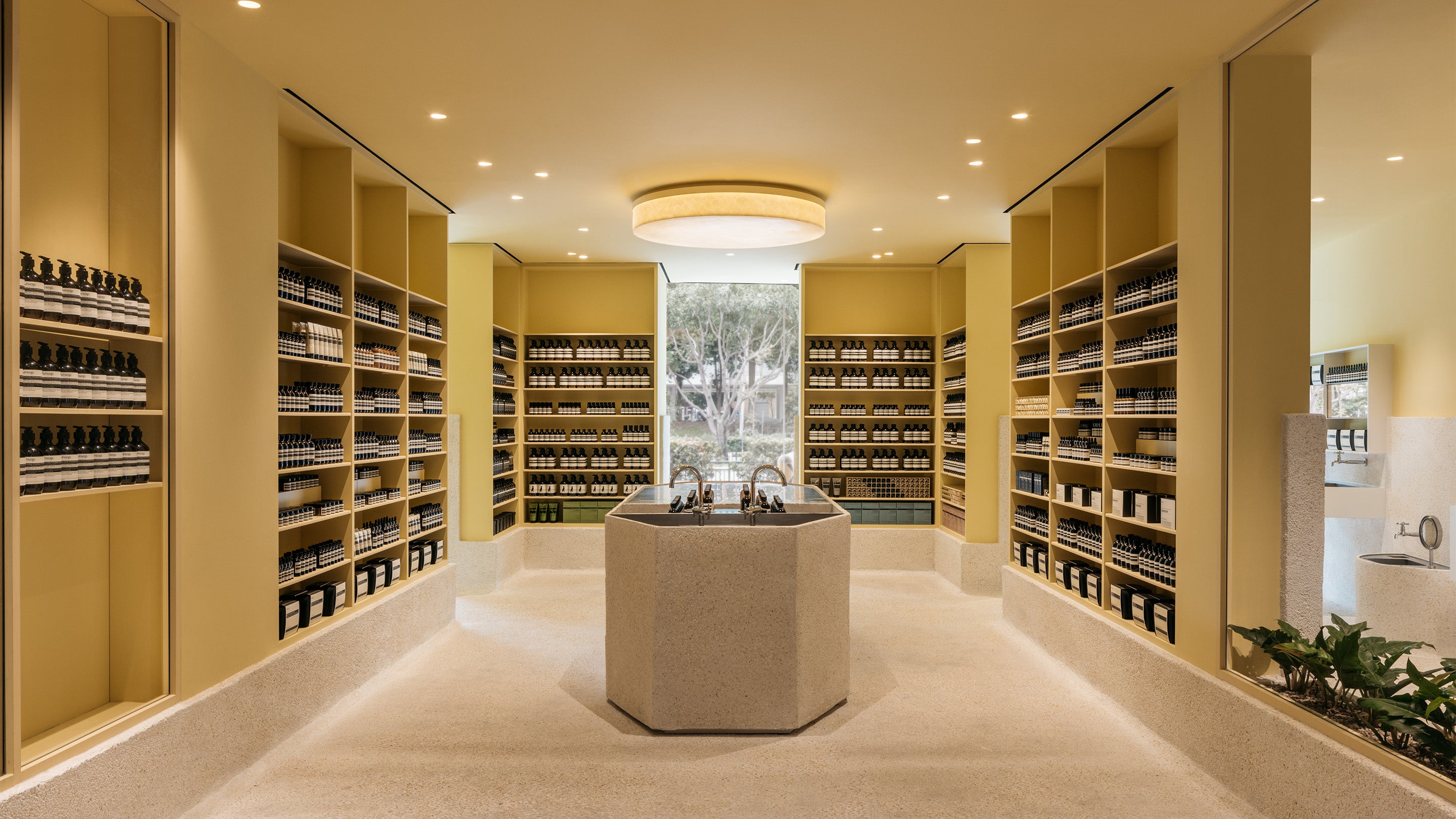 Aesop Tampines store with beige walls displaying Aesop products